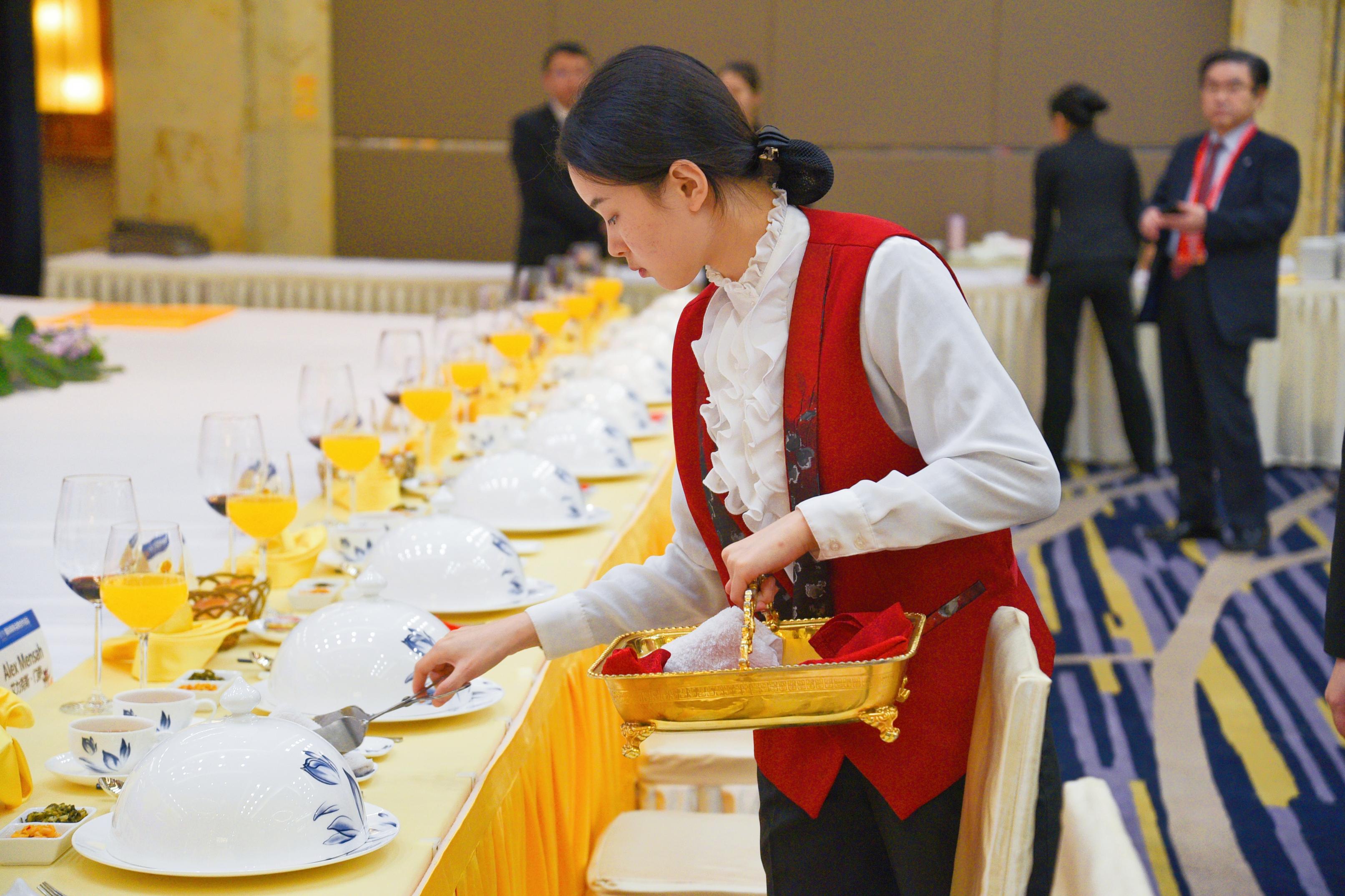 湖南赏金女王大酒店餐饮部员工正在布置会议现场。.jpg